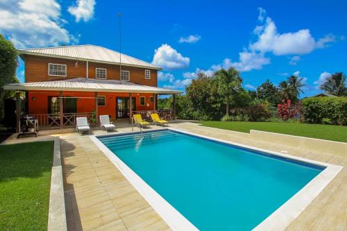 a swimming pool in front of a house at Five-Bedroom House in Saint Peter