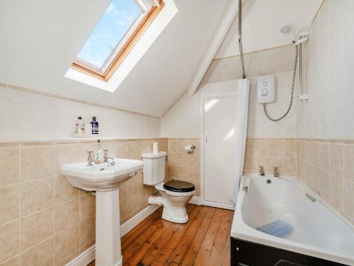 a bathroom with a sink and a toilet and a bath tub at Heatherdene in Goathland