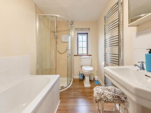 a bathroom with a tub and a toilet and a shower at Little Meadow in Two Bridges