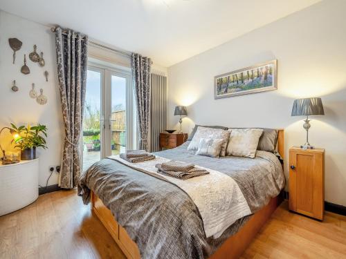 a bedroom with a bed and a large window at Hindscarth Apartment - Uk39610 in Davidstow