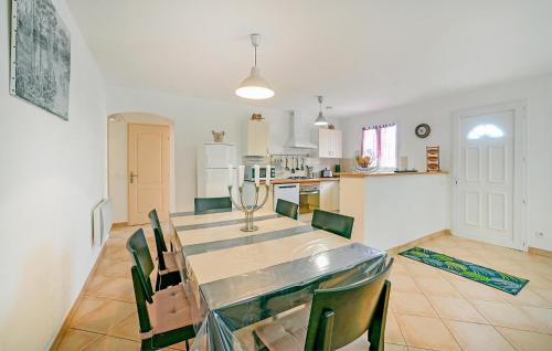 a dining room and kitchen with a table and chairs at Lovely Home In Bordezac With Wifi in Bordezac