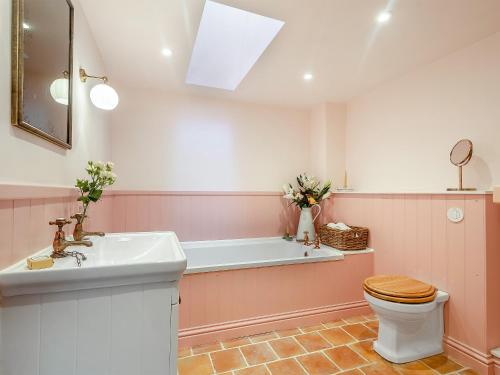 a bathroom with a sink and a toilet and a tub at Beiras Garden, Knockendoch in New Abbey