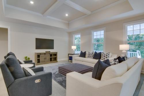 a living room with white furniture and a flat screen tv at Beach House with Deck and Pool Access in Rehoboth in Rehoboth Beach