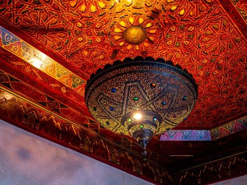 a ceiling with a chandelier on top of it at Dar Les Cigognes in Marrakech