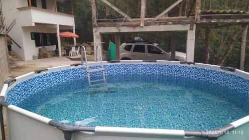 a large pool of blue water in a yard at el paraiso de juanjo in San Carlos