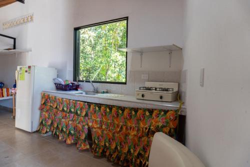 a kitchen with a counter with a window at el paraiso de juanjo in San Carlos