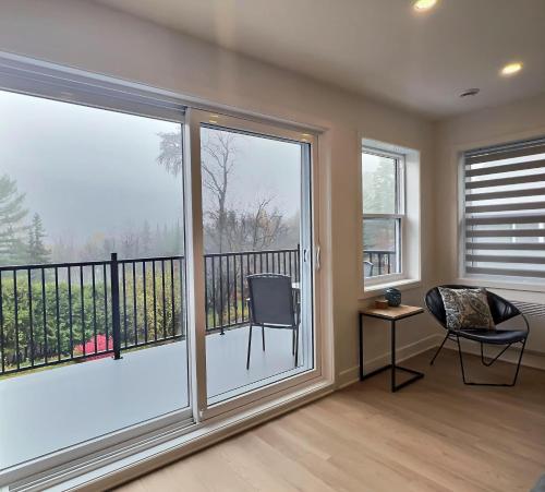 a room with a large window with a balcony at Le domaine du Sous-Bois in Mont-Blanc