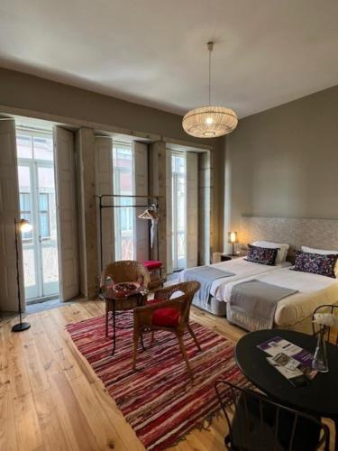 a bedroom with a large bed and a table at bnapartments Rio in Porto