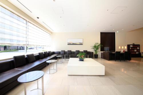 a large lobby with a white table and chairs at Richmond Hotel Fukushima Ekimae in Fukushima