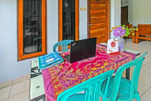 a table with a laptop computer on top of it at Wisma Dhana Syariah in Praya