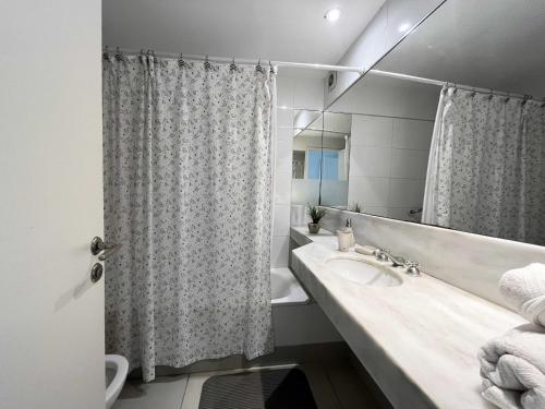 une salle de bain avec un lavabo et un rideau de douche dans l'établissement Depto Al A - Depto Zona Playa Grande para 4 PAX Con Cochera - Hola Sur, à Mar del Plata