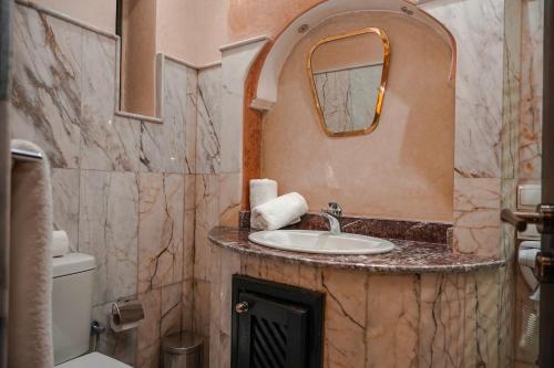 a bathroom with a sink and a mirror at Riad Roummana Marrakech in Marrakesh