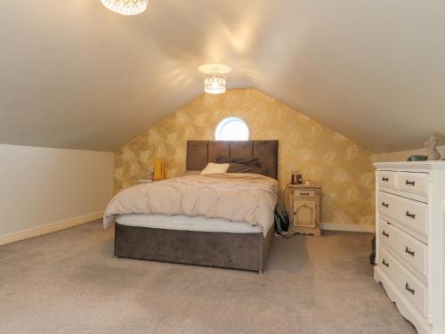 a bedroom with a large bed in a attic at Linwood in Thornton