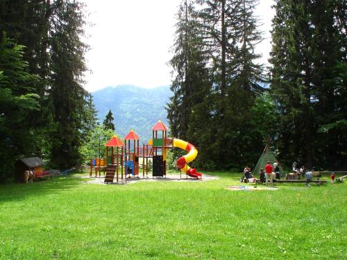 a park with a playground in a grass field at nawu apartments & Restaurant in Hermagor