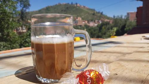 a glass mug of beer sitting on top of a table at Family House-Ciclovía Sucre-Bol in Sucre