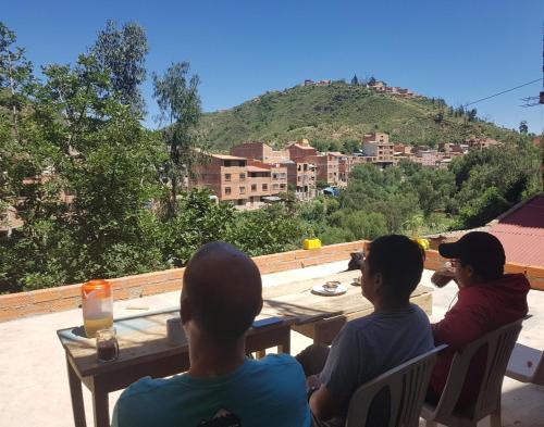 a group of people sitting at a table overlooking a city at Family House-Ciclovía Sucre-Bol in Sucre