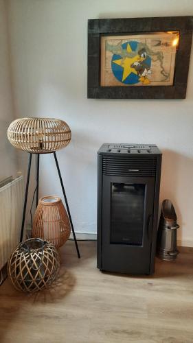 a television sitting in a living room with a table at Kustverhuur, Vakantiepark Fort Soleil 43 in Breskens