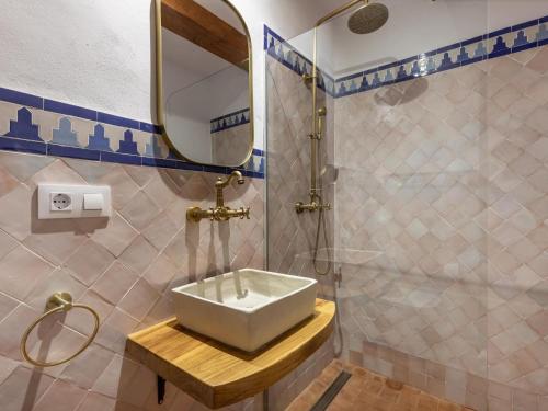 a bathroom with a sink and a shower at Alhambra Luxury Albaicin in Granada