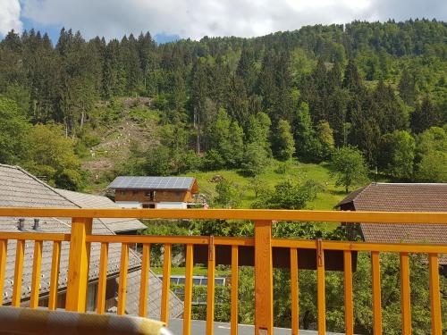 a wooden deck with a view of a mountain at nawu apartments & Restaurant in Hermagor