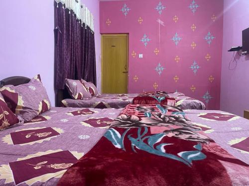 a bedroom with a bed with purple walls at Hotel PNR'S Paradise in Ooty