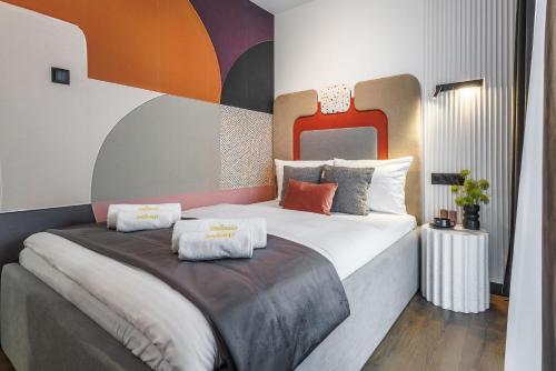 a bedroom with a large bed with two pillows on it at Emihouse Riverside Apartments in Rzeszów