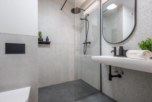 a bathroom with a sink and a mirror at Emihouse Riverside Apartments in Rzeszów