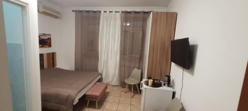 a small bedroom with a bed and a television at B&B Piazza Ragusa in Rome