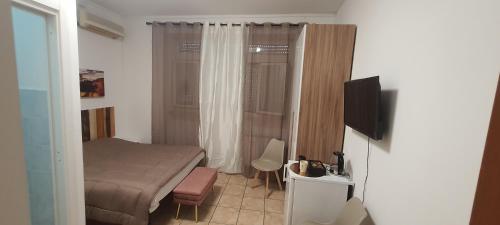 a small bedroom with a bed and a television at B&B Piazza Ragusa in Rome
