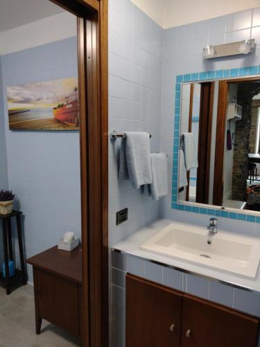 a bathroom with a sink and a mirror at CasAle sul Lago di Como in Blevio