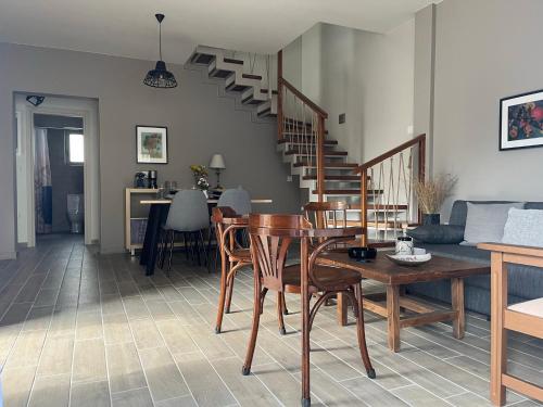 a living room with a table and chairs and stairs at Easy Living 1 & 2 in Kos Town