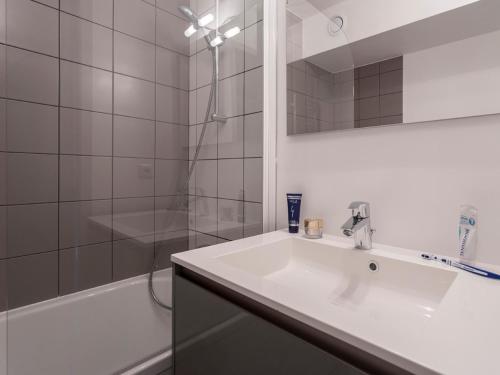 a white bathroom with a sink and a shower at Studio Les Arcs 2000, 1 pièce, 5 personnes - FR-1-346-378 in Arc 2000