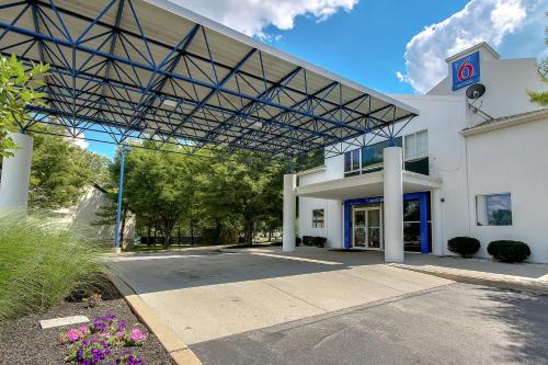 a large white building with a large metal roof at Motel 6 King Of Prussia PA in King of Prussia