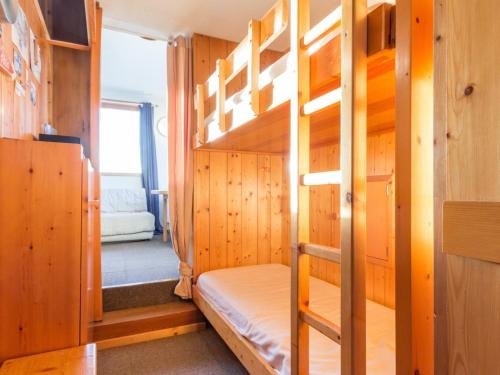 a bunk bed in a room with wooden walls at Appartement Les Arcs 1800, 2 pièces, 4 personnes - FR-1-346-497 in Arc 1800