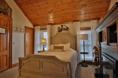 a bedroom with a bed and a wooden ceiling at Cloran Mansion Bed & Breakfast in Galena
