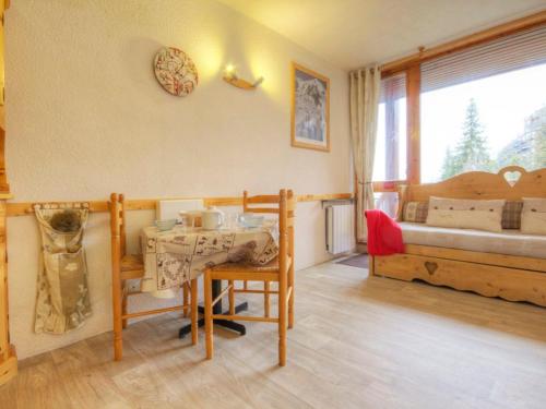a room with a table and a bedroom with a bed at Studio Les Arcs 1800, 1 pièce, 3 personnes - FR-1-346-473 in Arc 1800