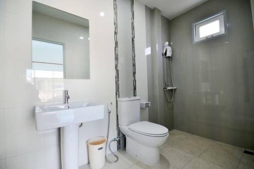 a bathroom with a toilet and a sink at The Guestvilla644 in Hua Hin