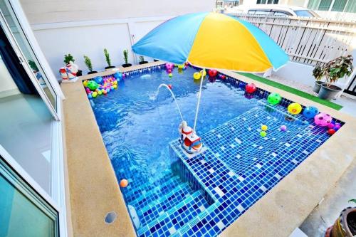 a pool with a toy car and an umbrella at The Guestvilla644 in Hua Hin