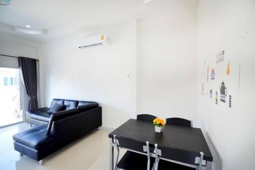 a living room with a couch and a table at The Guestvilla644 in Hua Hin