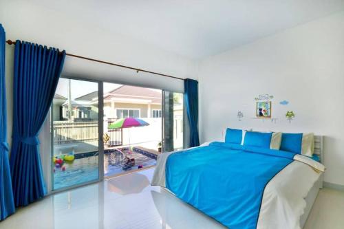 a bedroom with a bed and a view of a pool at The Guestvilla644 in Hua Hin