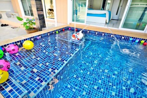 a swimming pool with balls and toys in the water at The Guestvilla644 in Hua Hin