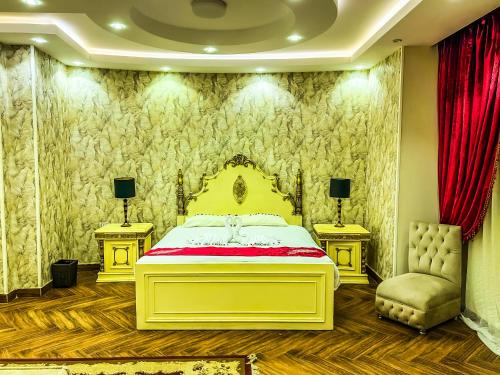 a bedroom with a yellow bed and two chairs at Purity Pyramids View Palace in Cairo