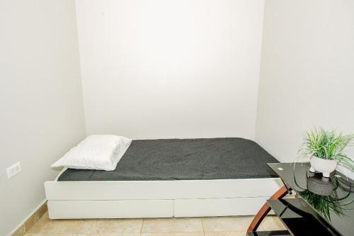 a white bedroom with a bed in a room at EcoMar Rentals in Cabo Rojo