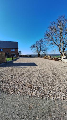 a large gravel parking lot in front of a building at Lu Bê mont in Stavelot