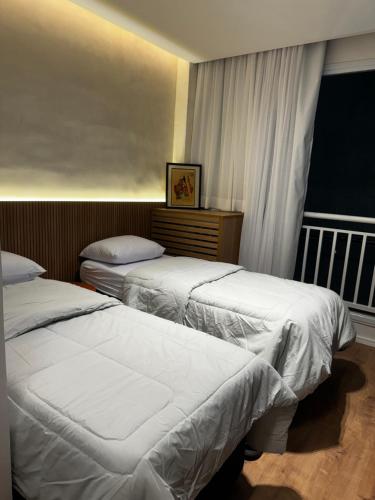 מיטה או מיטות בחדר ב-Studio Itaquera Neoquimica Arena