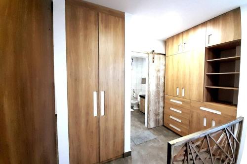 a room with wooden cabinets and a staircase at Moderna Casa vista al mar San Jose,Ruta Spondylus in La Curia