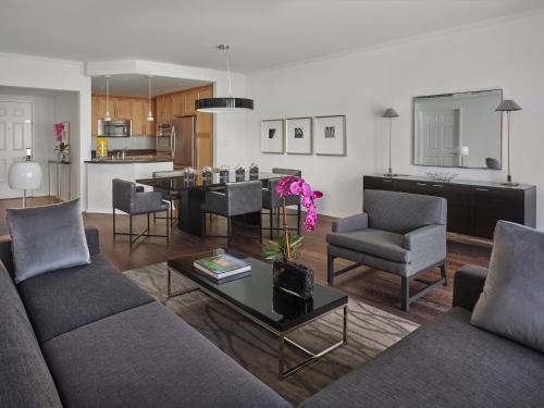a living room with a couch and a table at AKA Beverly Hills in Los Angeles