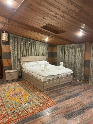 a bedroom with a bed and a large rug at Poolside Argel in Argel