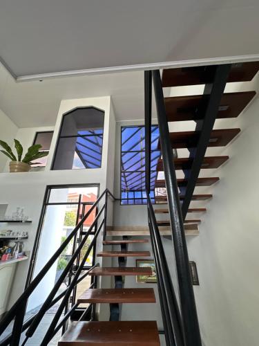 a staircase in a house with stained glass windows at Villa Celajes in Barva