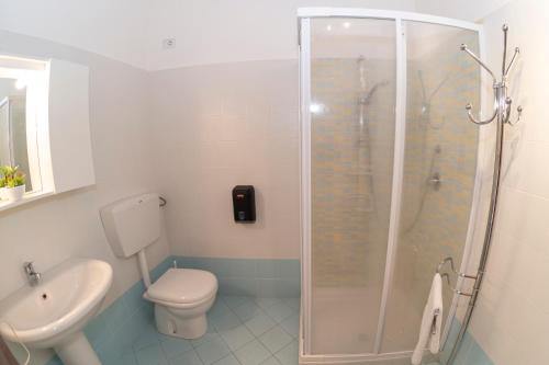 a bathroom with a shower and a toilet and a sink at "Il Segreto" Vista Panoramica sulle Isole Eolie con Piscina, palestra e WiFi in Patti