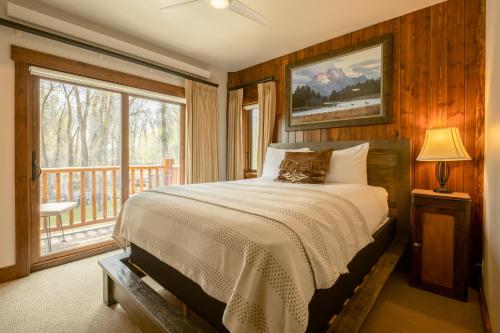 a bedroom with a bed and a large window at Bentwood Inn in Wilson